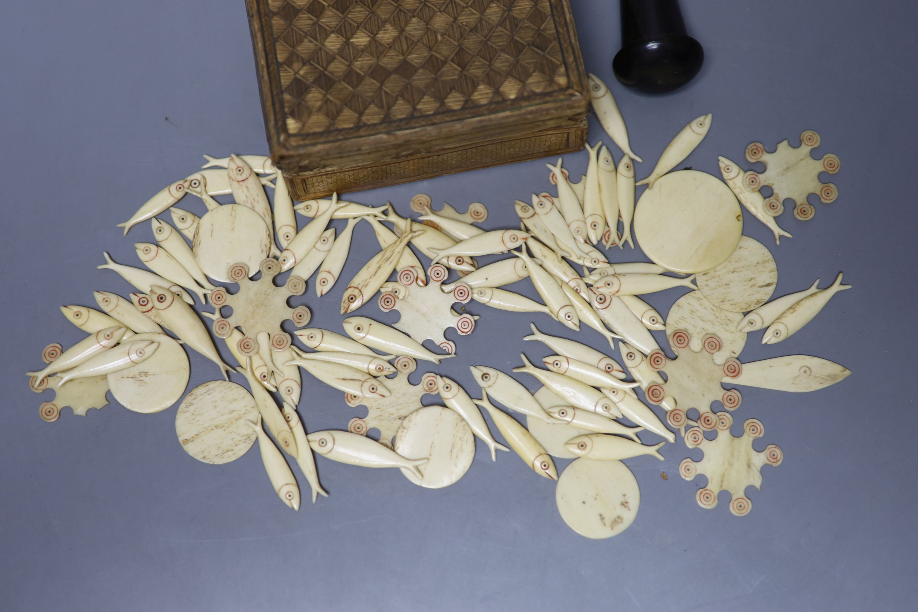 A small quantity of Victorian bone gaming counters, contained within straw work box and a dice shaker containing five dice